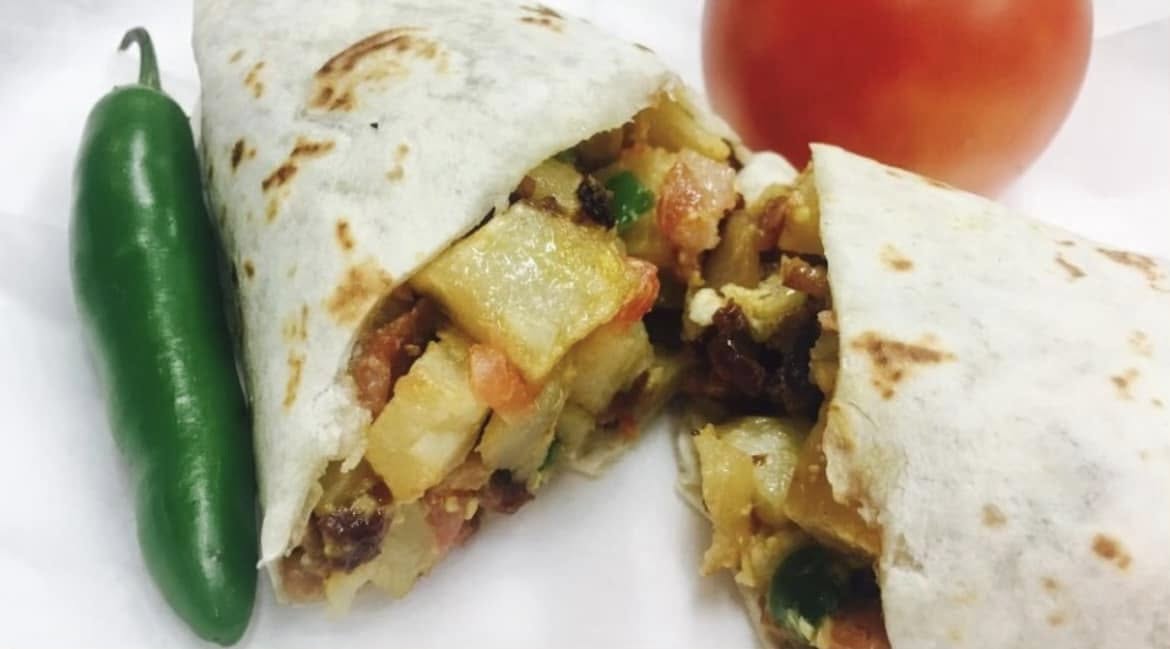 Chorizo, egg and potato breakfast burrito cut in half